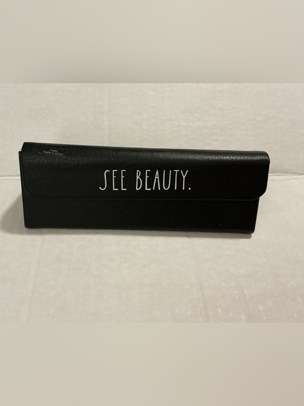 Rae Dunn Black Sunglass Case with "SEE BEAUTY." Text